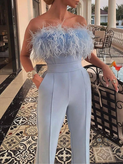 White strapless wide-leg jumpsuit with feather trim from Trendsi, showcasing its flowing fabric and stylish design.