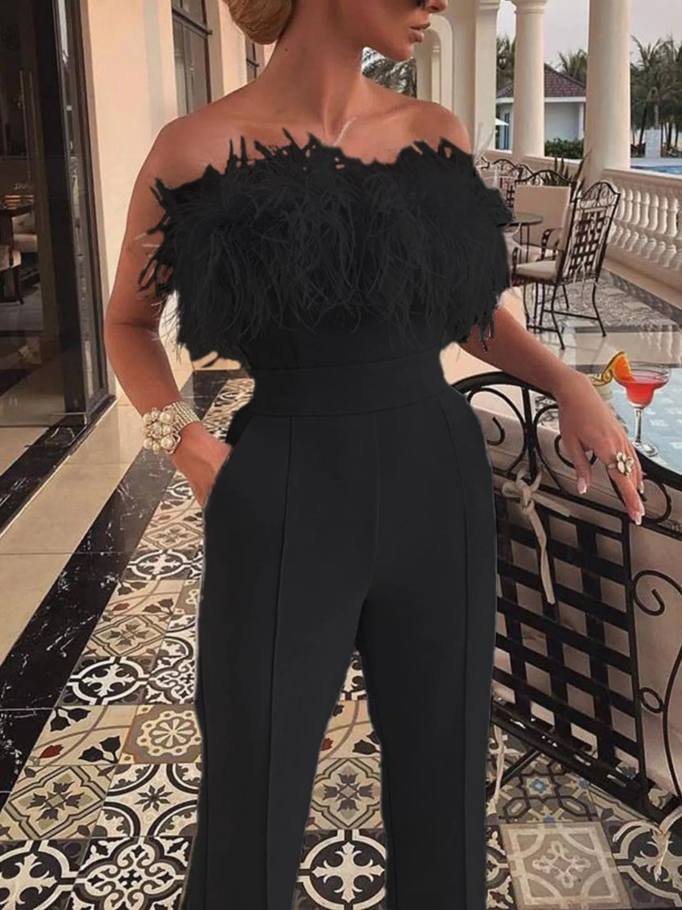 White feather-trim strapless wide-leg jumpsuit by Trendsi, featuring a fitted bodice and flowing pant legs.