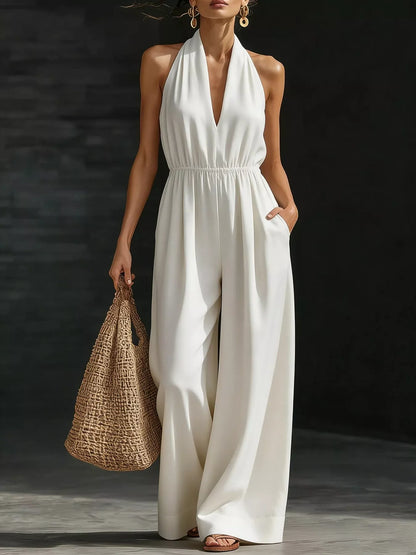 Plus size white halter neck wide-leg jumpsuit by Trendsi, full-length view showcasing the stylish, flowy design.