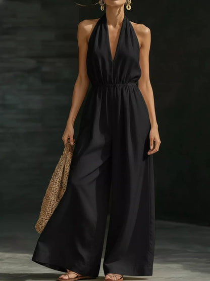White plus size halter neck wide-leg jumpsuit by Trendsi, full-length view showcasing stylish, flowy silhouette.