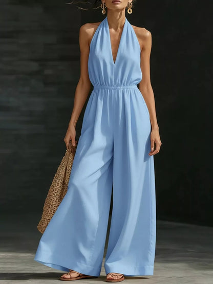 Plus size white halter neck jumpsuit with wide-leg design from Trendsi, full-length and stylish for casual or dressy occasions.