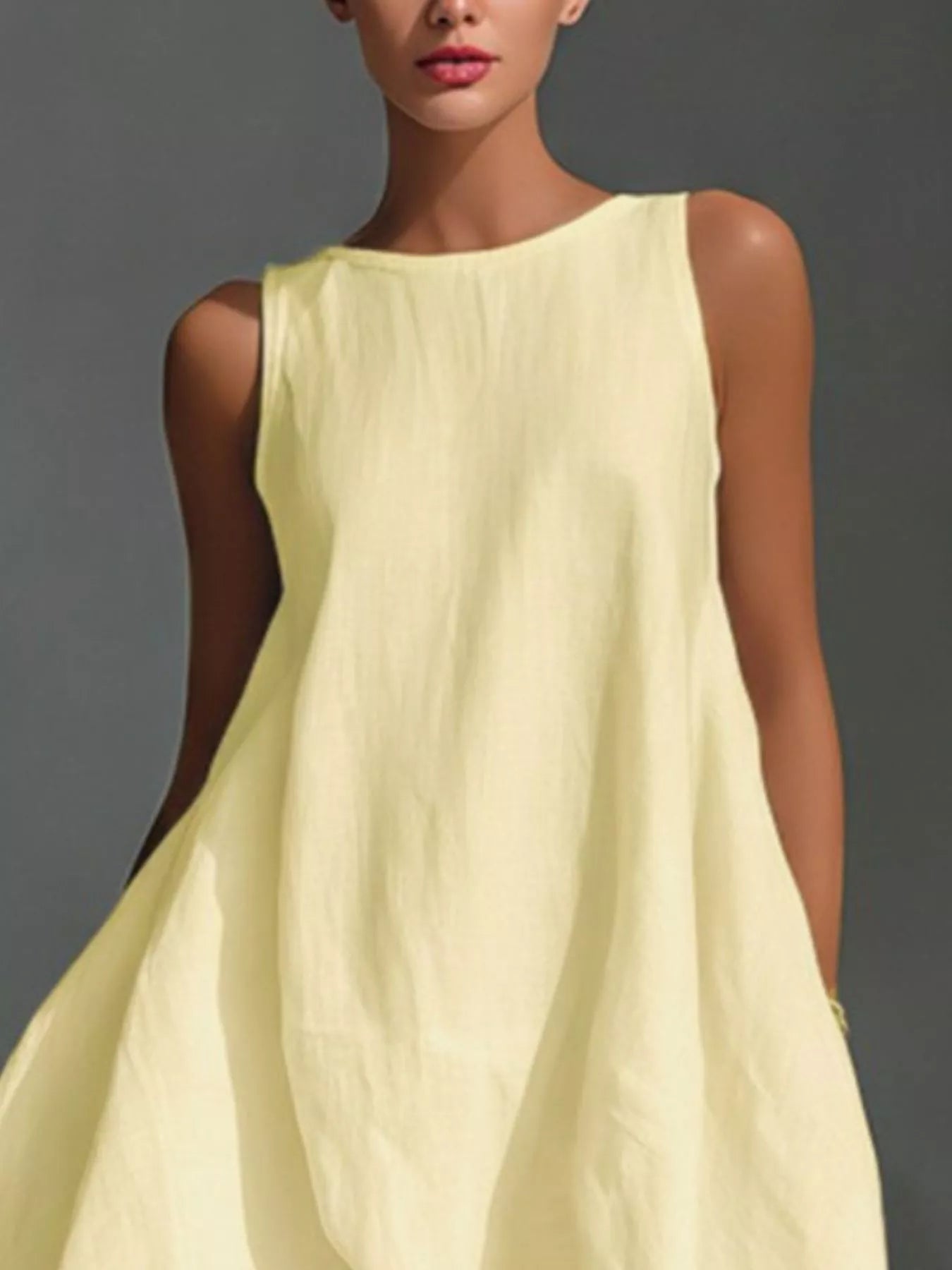 White high-low sleeveless dress with round neckline by Trendsi, featuring a flowing silhouette and stylish design.