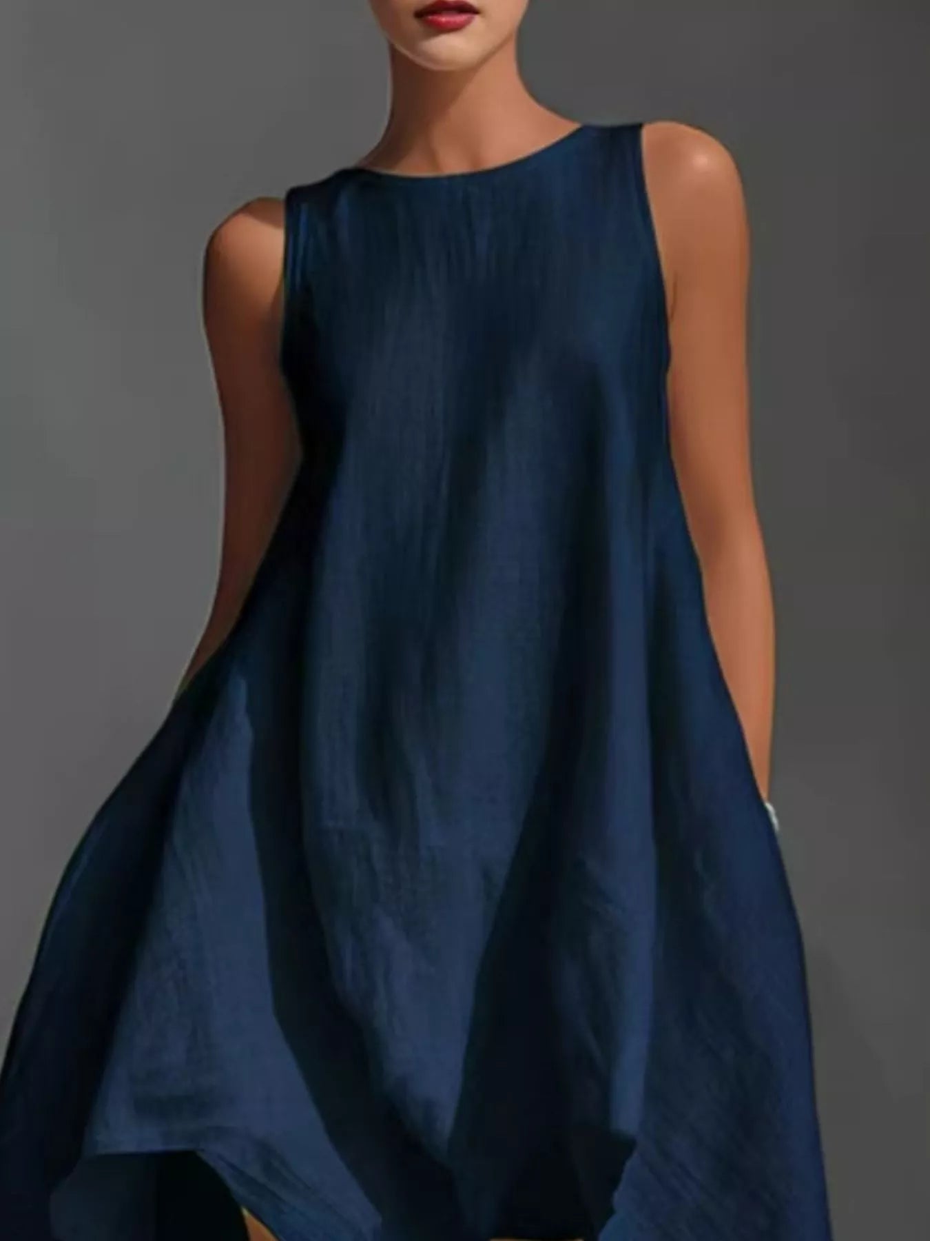 White high-low sleeveless dress with round neckline from Trendsi, showcasing a flowing, stylish design perfect for casual or semi-formal wear.