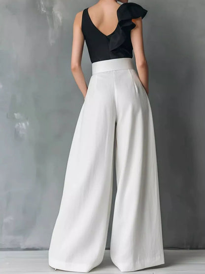 High-waisted wide-leg pants from Trendsi, featuring a flowy fit and tailored waistband, shown in a natural pose.