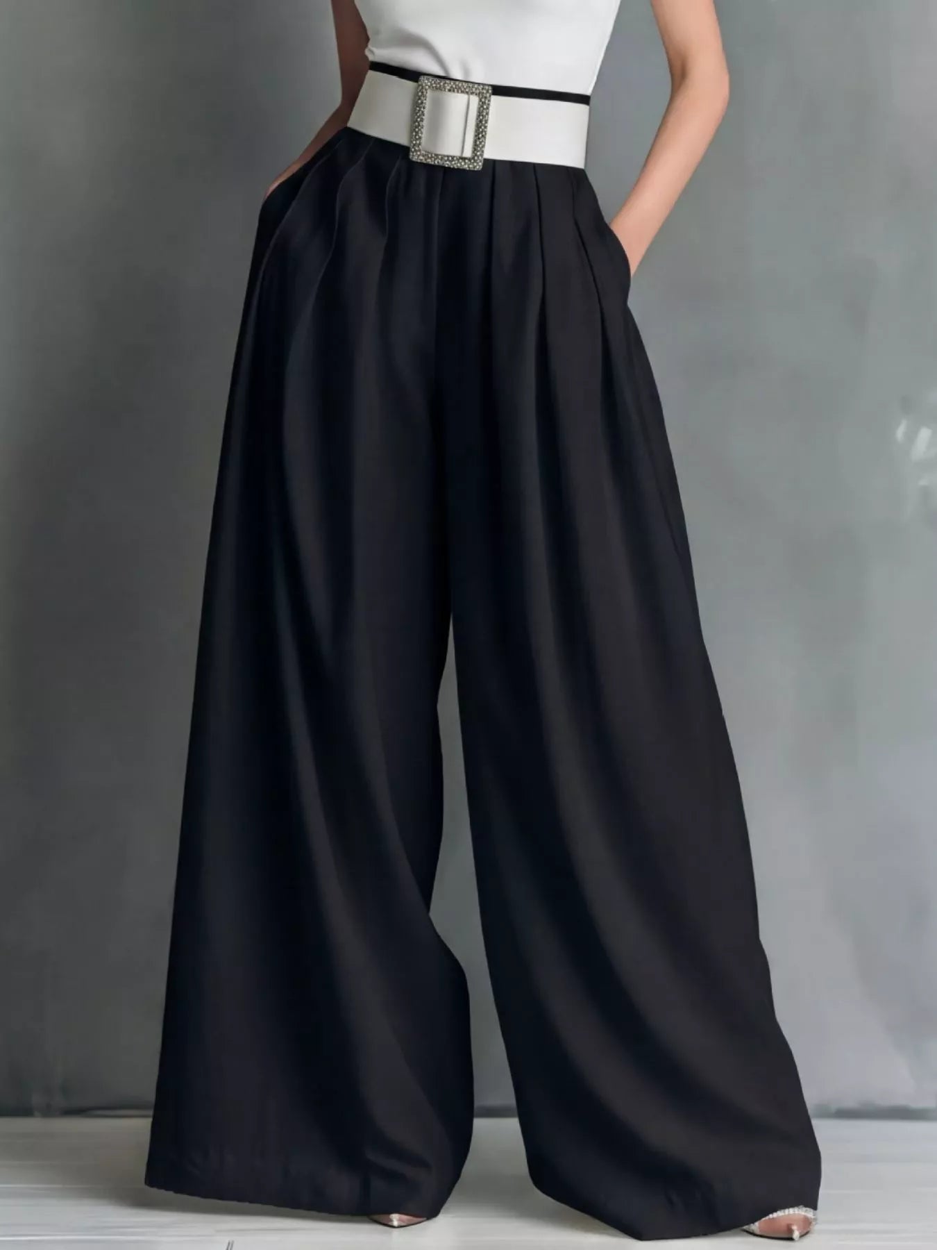 High-waisted wide-leg pants by Trendsi, styled with a casual top, showcasing a relaxed fit and flowing fabric.