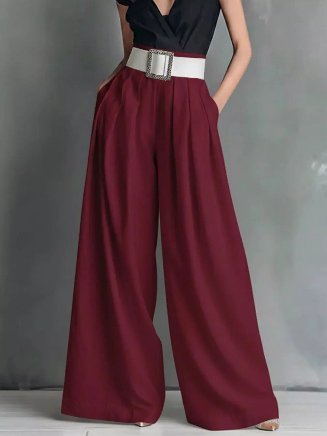 High-waisted wide-leg pants by Trendsi, featuring a flowing fit and neutral color, displayed on a model.