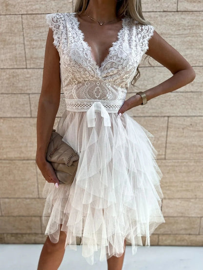 Lace V-neck ruffle dress by Trendsi featuring intricate lace details and flowing ruffle accents on a stylish dress.