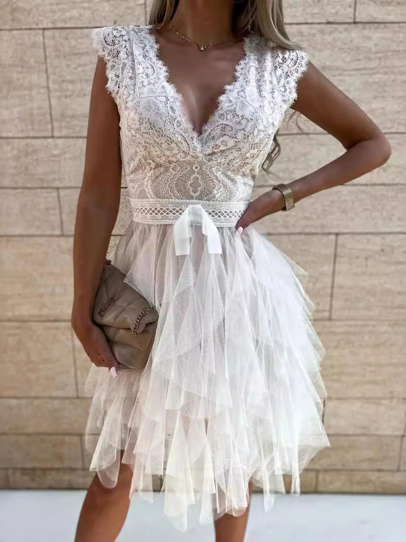 Lace V-neck ruffle dress from Trendsi featuring delicate lace fabric and flowing ruffle details at the neckline and hem.