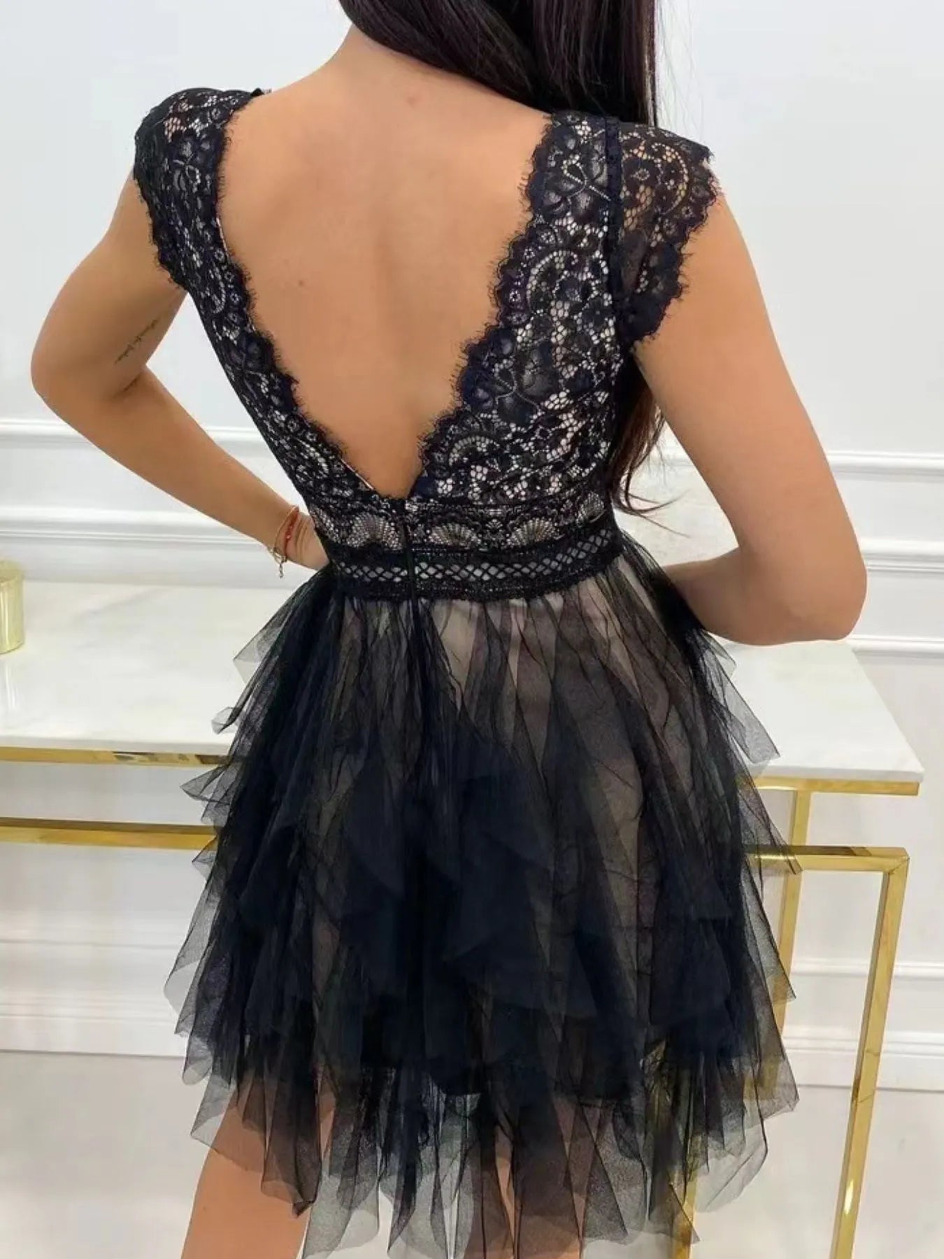 Lace V-neck ruffle dress by Trendsi featuring delicate lace fabric and flowing ruffle details on the neckline.