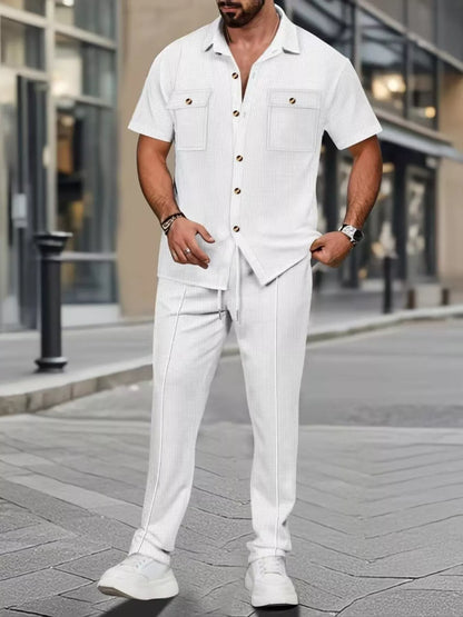 Men's casual short sleeve shirt and pants set in plus size by Trendsi, featuring a relaxed fit in white.