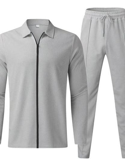 Men's plus size white zip-up top and pants set by Trendsi, casual and comfortable full-length athletic loungewear.