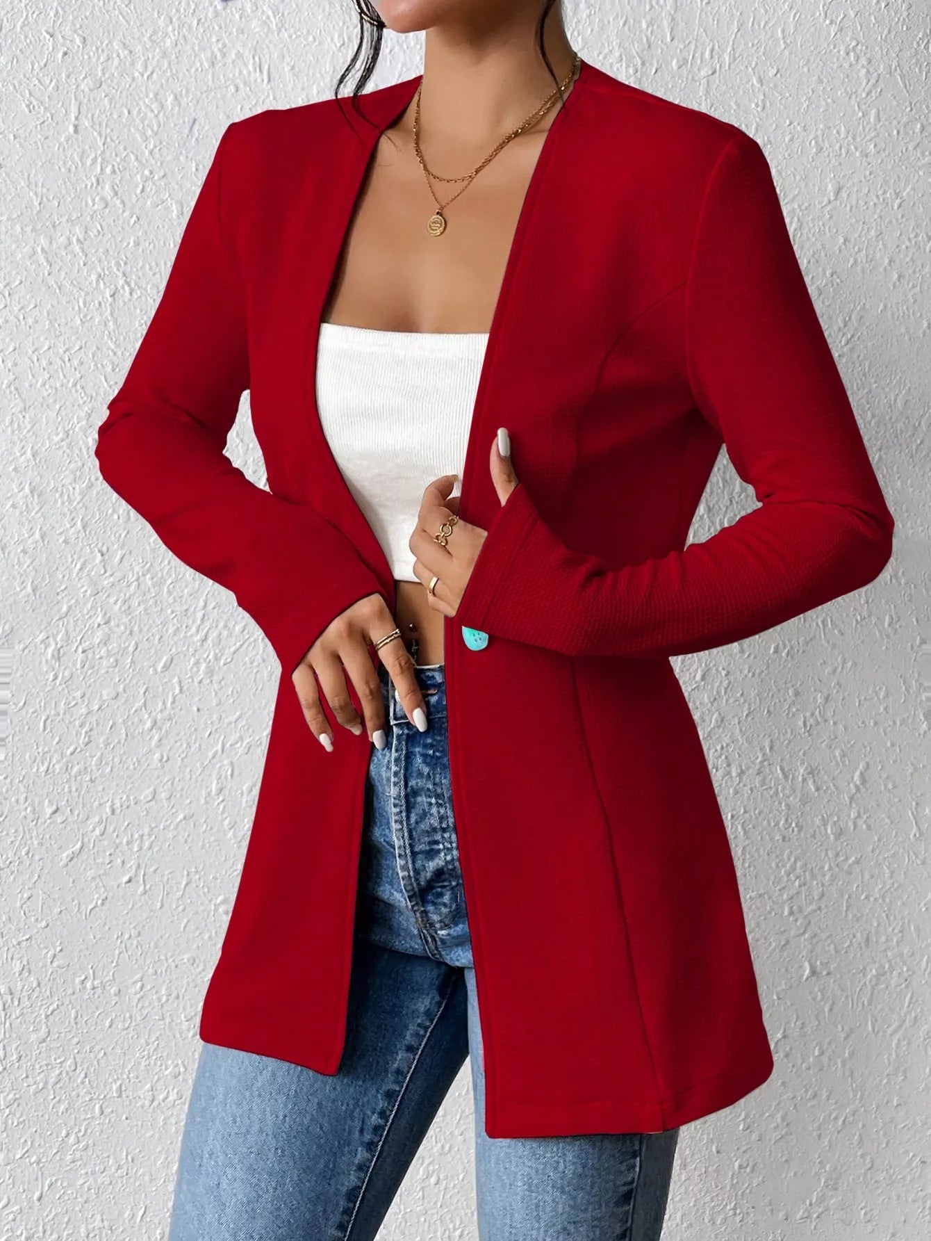 Black one-button long sleeve blazer by Trendsi, featuring a tailored fit and classic lapel, shown on a mannequin.