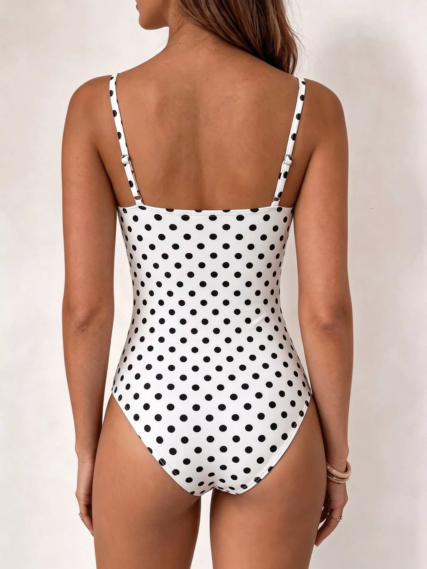 Polka dot cowl neck spaghetti strap bodysuit by Trendsi featuring a stylish design and comfortable fit.