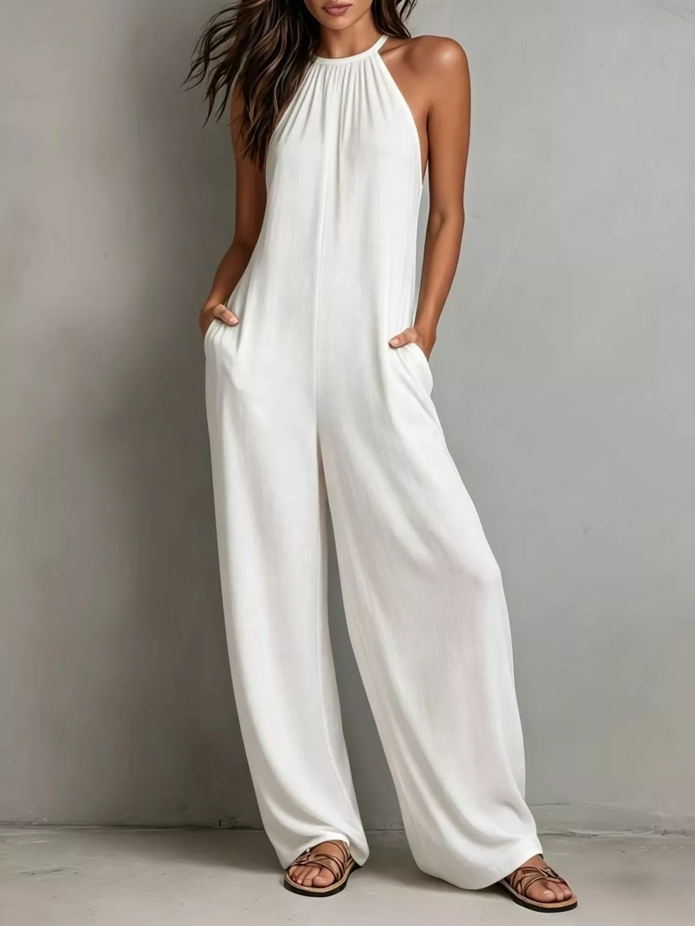 White sleeveless wide-leg jumpsuit by Trendsi, featuring a stylish fit and flowy design perfect for casual or dressy occasions.