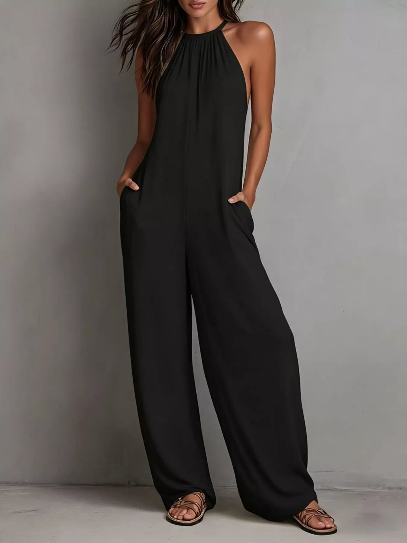 White sleeveless wide-leg jumpsuit by Trendsi, featuring a relaxed fit and flowing fabric, perfect for casual or summer wear.