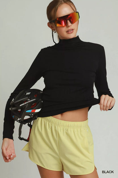 Black women's long sleeve mock neck top by Umgee, casual trendy top with fitted design and soft fabric.