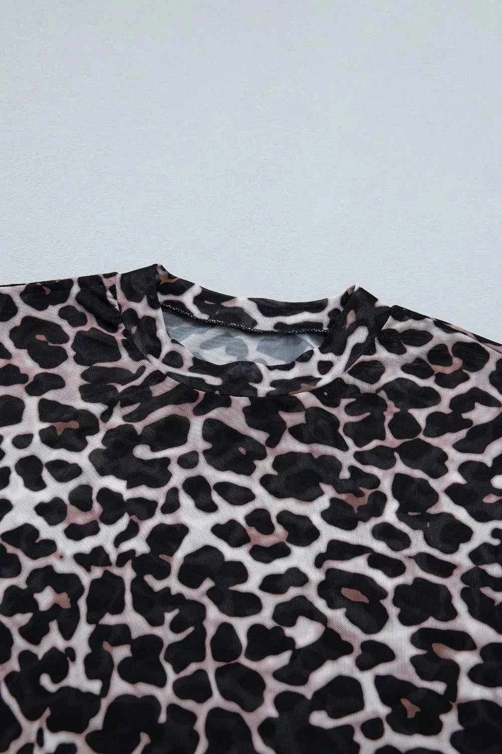 Leopard print sheer mesh top for women, stylish and versatile, featuring a chic design and lightweight fabric.