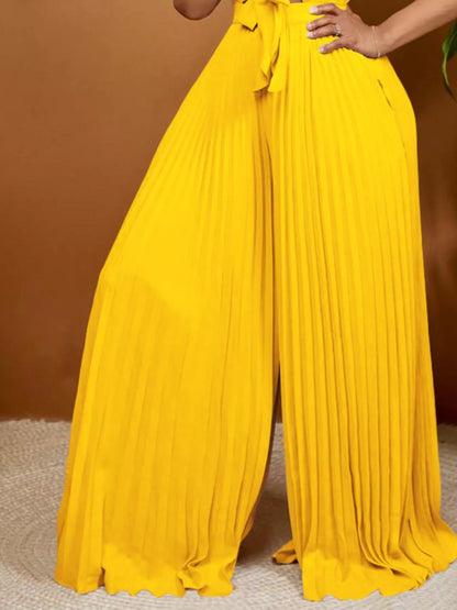 Yellow plus size tie-front pleated wide-leg jumpsuit by Trendsi, full-length view showcasing its stylish design.
