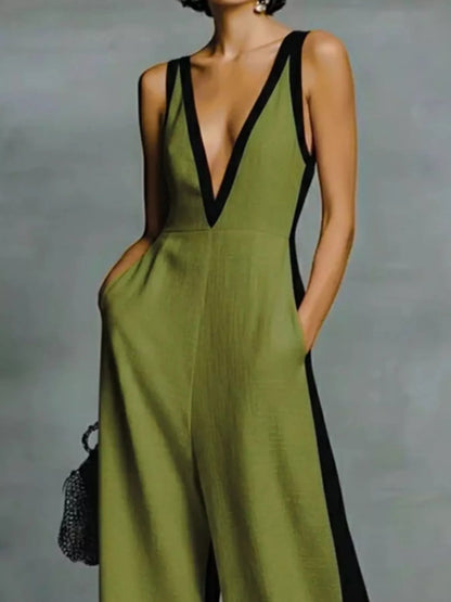 Deep V-neck wide-leg jumpsuit with contrast trim, unbranded, shown on a model with a sleek, modern style.
