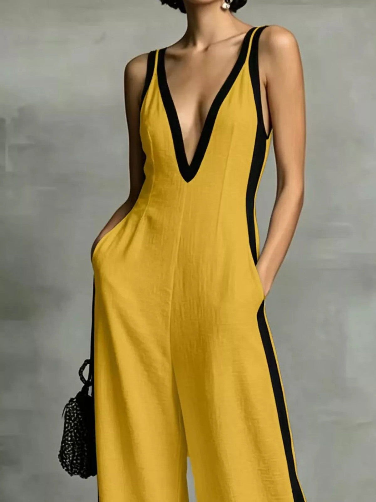 Deep V-neck wide-leg jumpsuit with contrast trim, unbranded, featuring a stylish and flowing design.