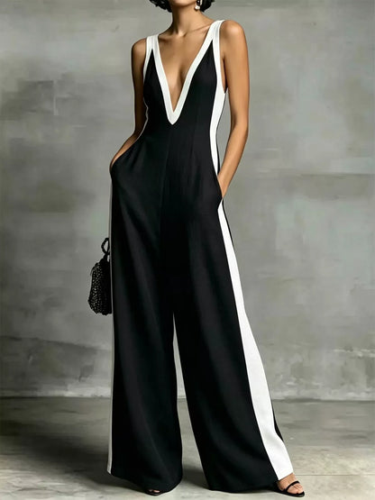 Deep V-neck wide-leg jumpsuit with contrast trim, stylish unbranded jumpsuit featuring a flattering fit and trendy design.
