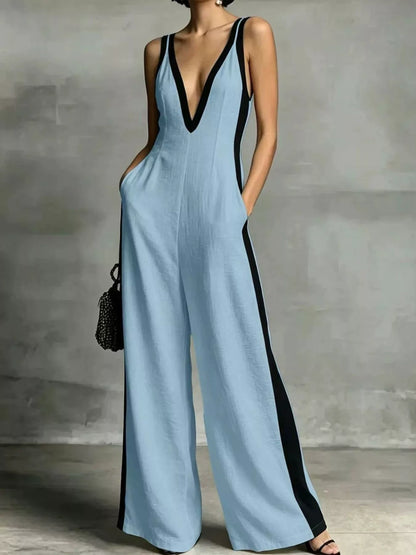 Deep V-neck wide-leg jumpsuit with contrast trim, featuring a stylish design and comfortable fit, displayed on a hanger.