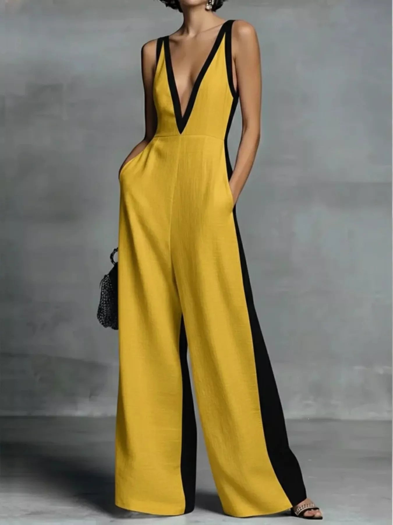 Deep V-neck wide-leg jumpsuit with contrast trim, unbranded, featuring a stylish cut and fabric details in the image.